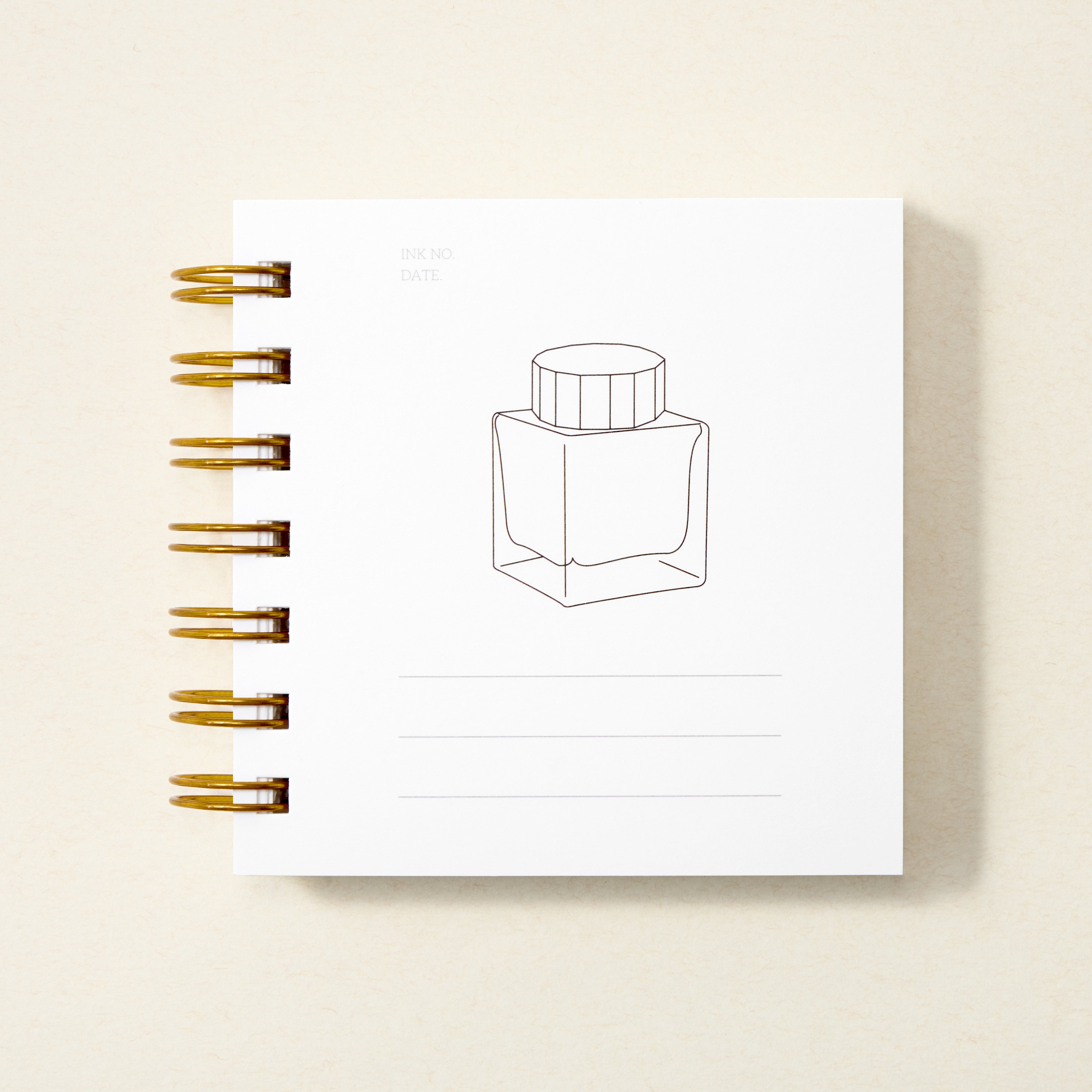 Ring bound book with white page with drawing of ink bottle