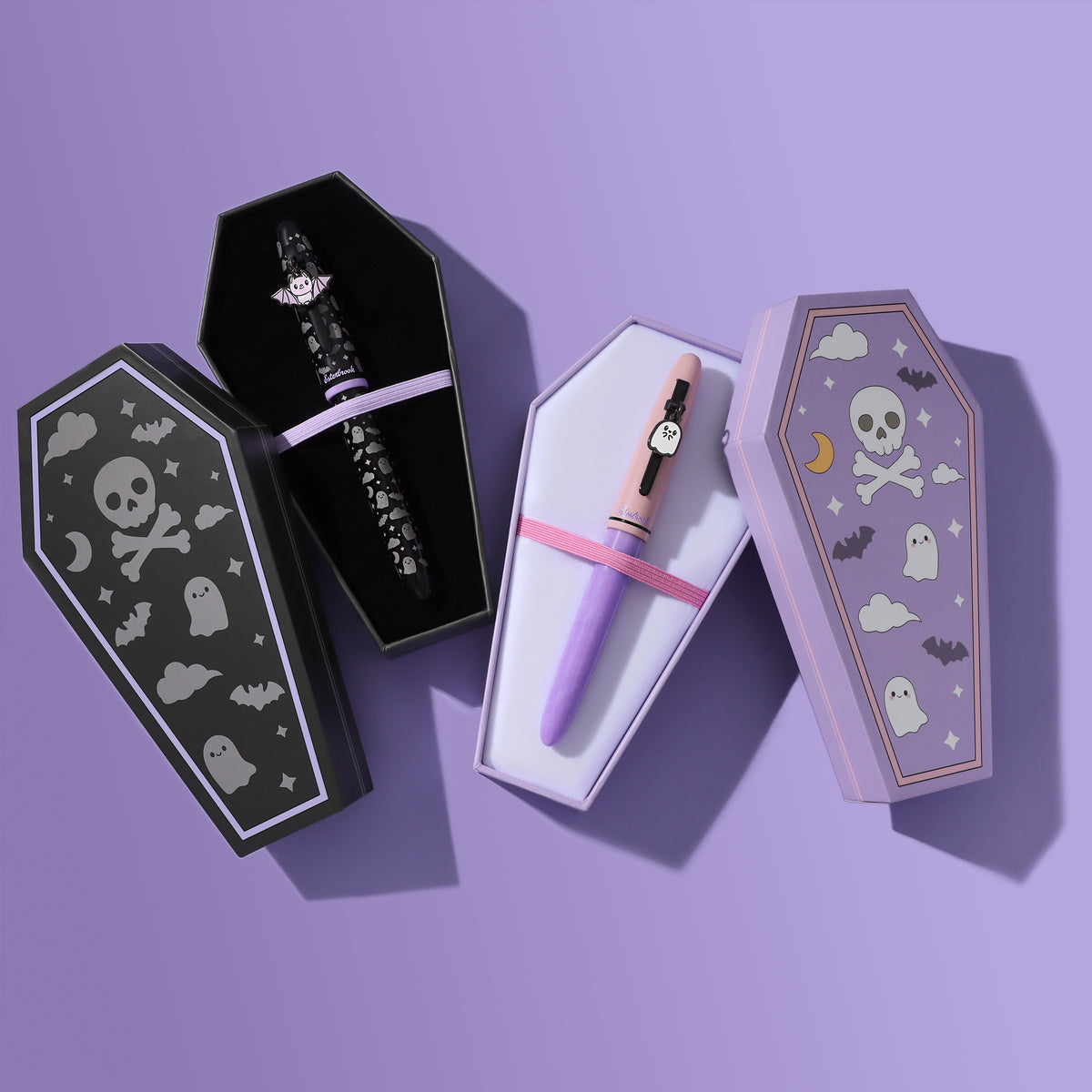 Pastel Halloween and Sweetly Haunted Estie fountain pens in their pastel purple and black coffin-shaped gift boxes