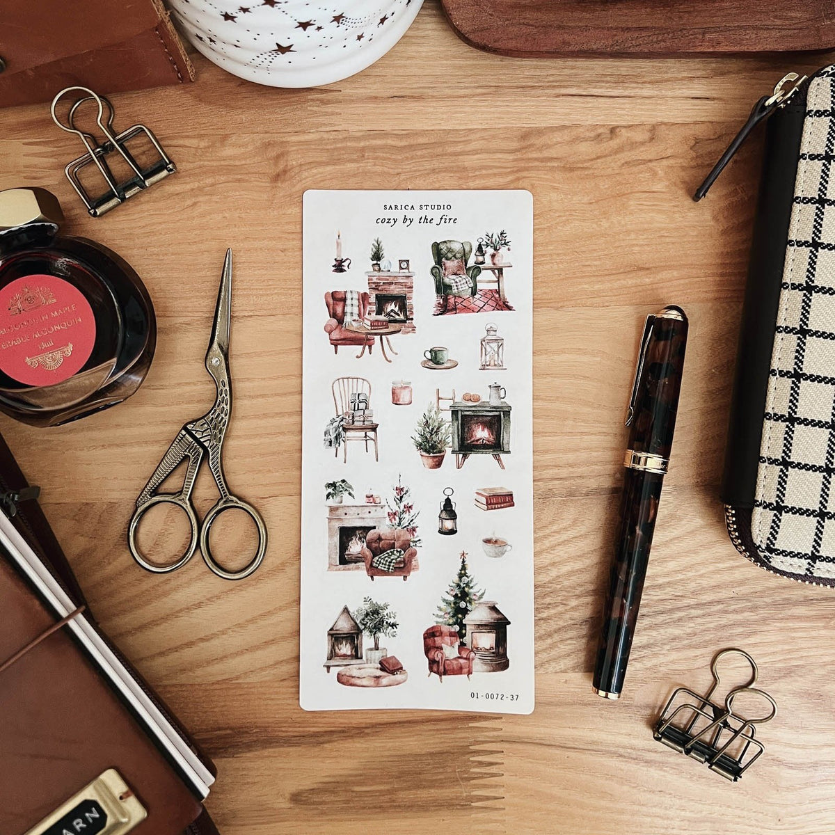 Sarica Studio Cozy by the Fire sticker sheet with a fountain pen, ink bottle and scissors