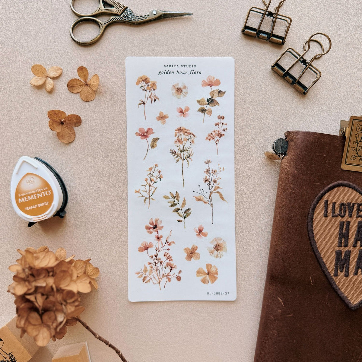Sarica Studio Golden Hour Flora stickers, sheet with dried hydrangeas and a leather notebook