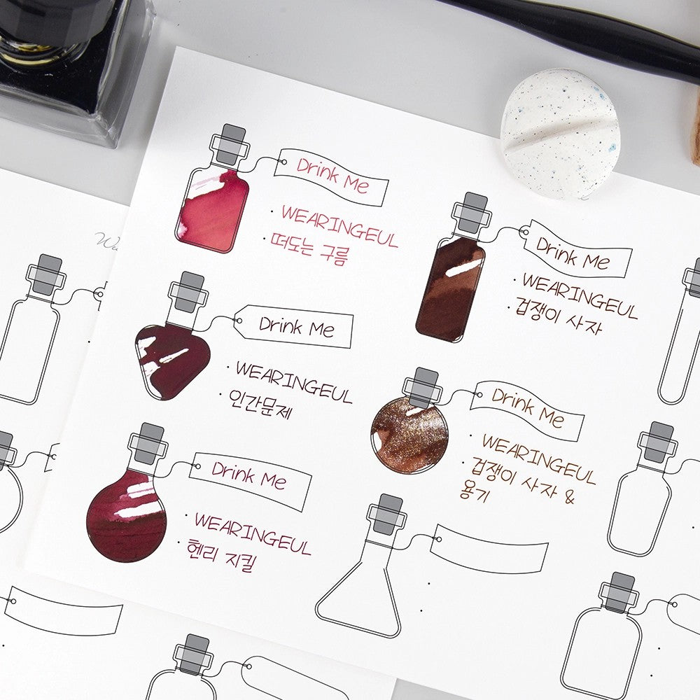 Alice's Potion swatch sheet with red and brown fountain pen ink swatches in potion bottles