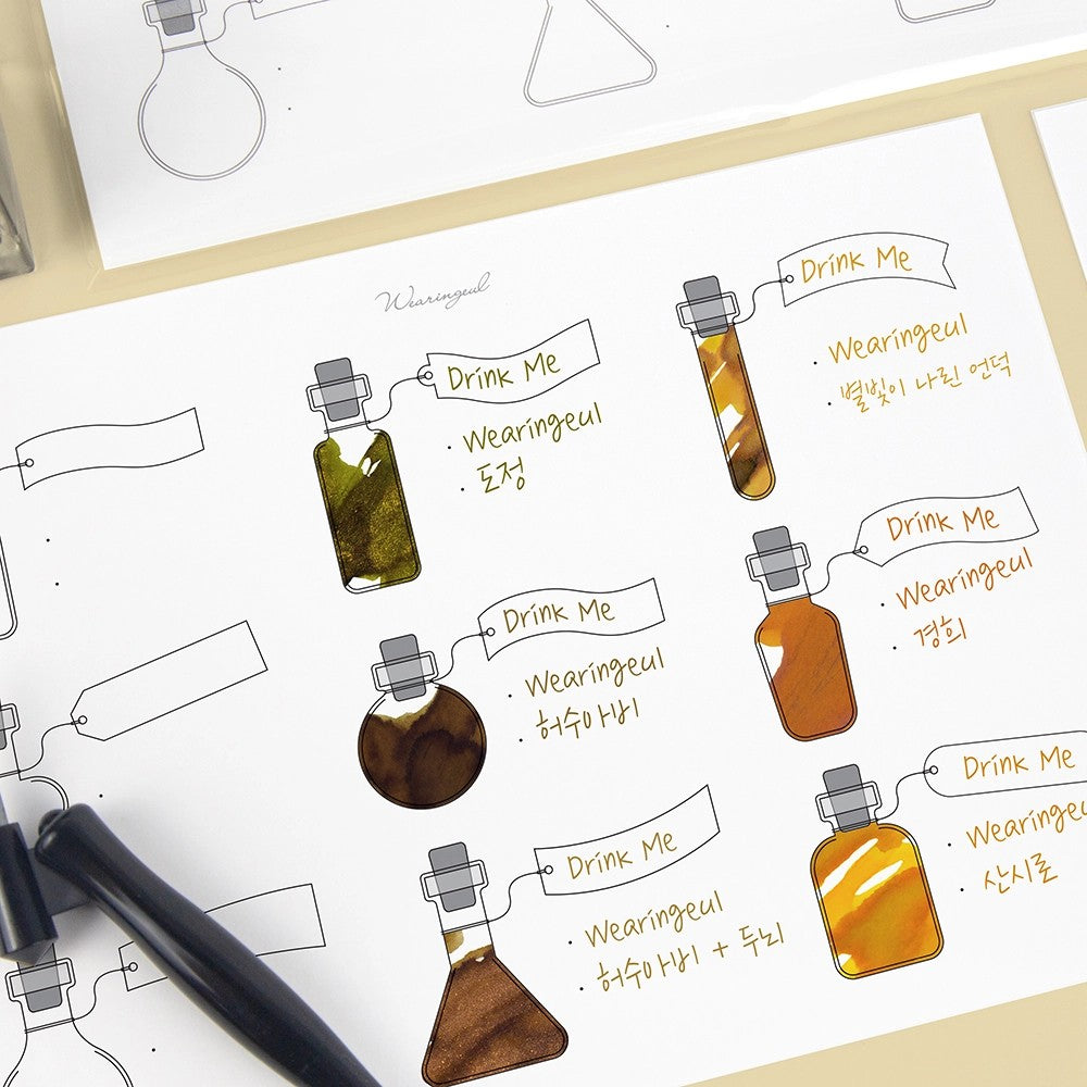 Alice's Potion swatch sheet with gold and amber ink swatches in potion bottles and labeled tags