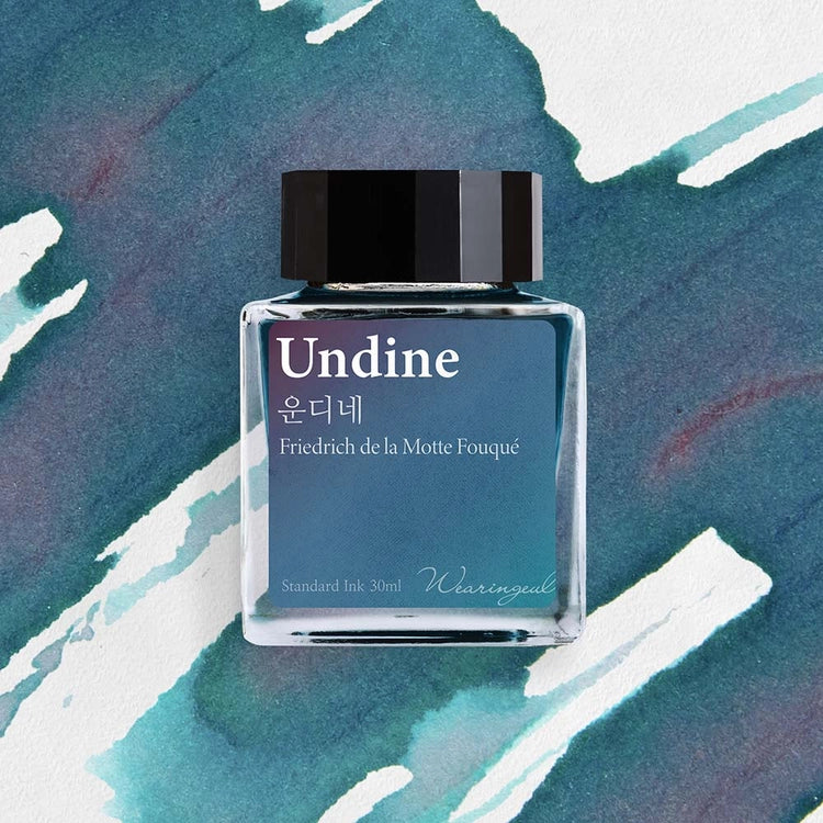 Wearingeul Undine fountain pen ink bottle with dark teal ink swatch background
