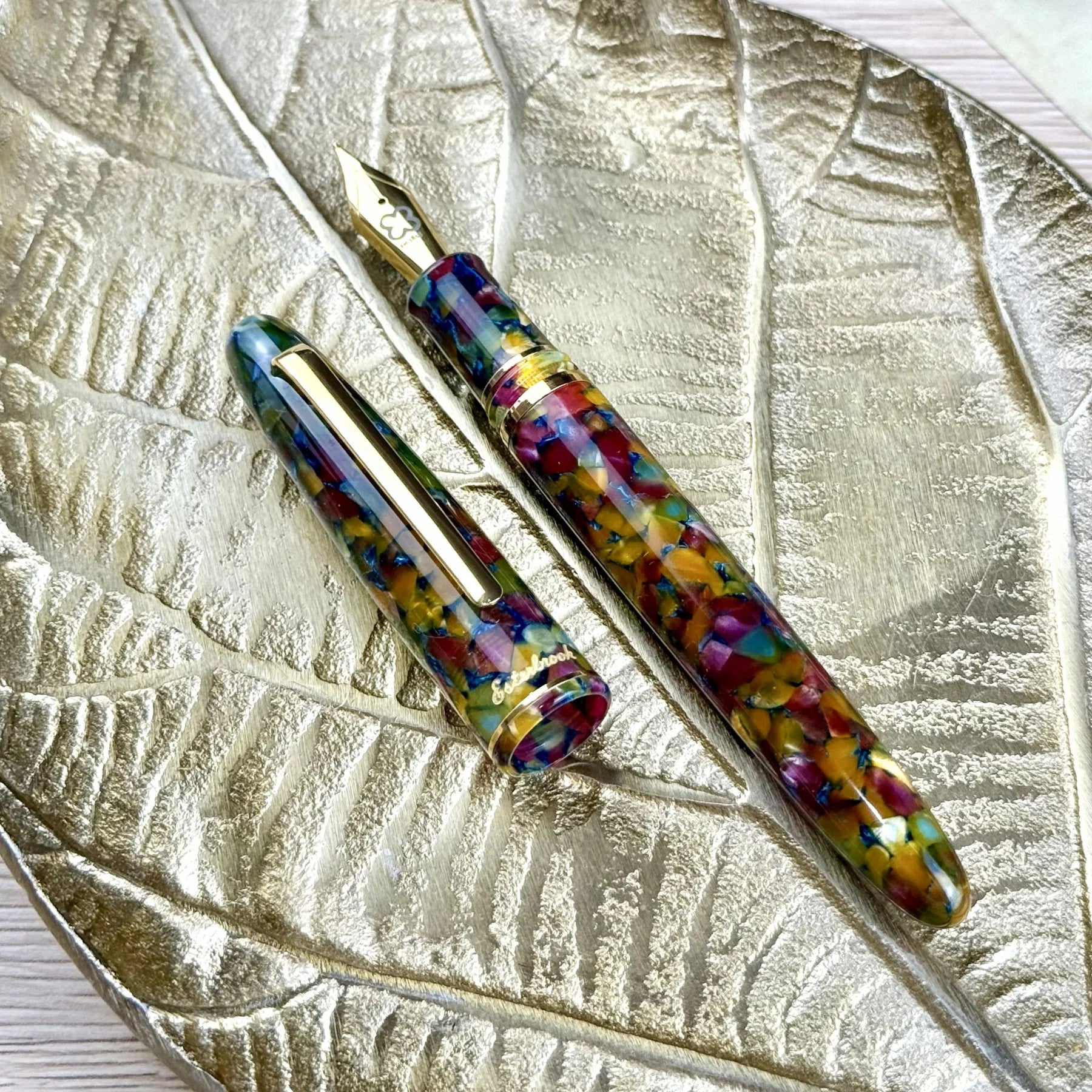 Esterbrook Estie Botanical Gardens fountain pen with gold trim, capped and uncapped on a gold leaf tray