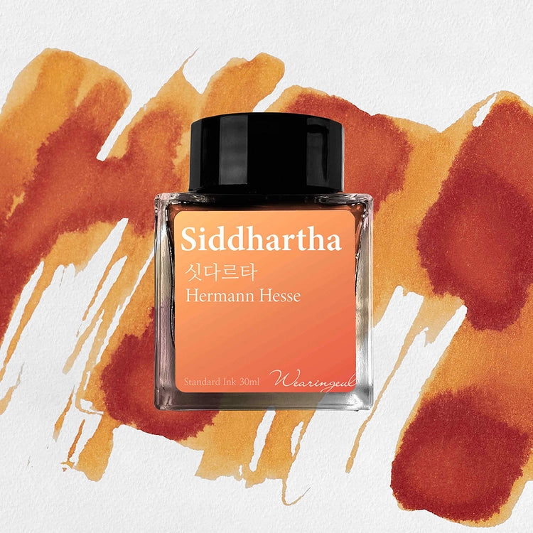 Wearingeul Siddhartha fountain pen ink bottle with yellow orange ink swatch background