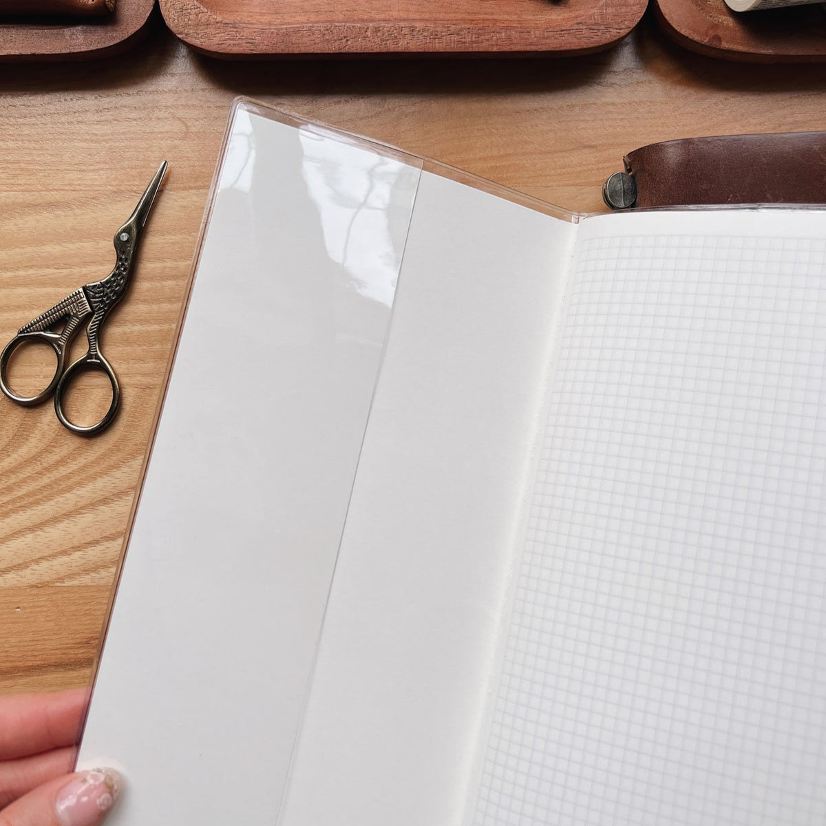 Sarica Studio standard size clear cover on an open notebook with gridded Tomoe River pages