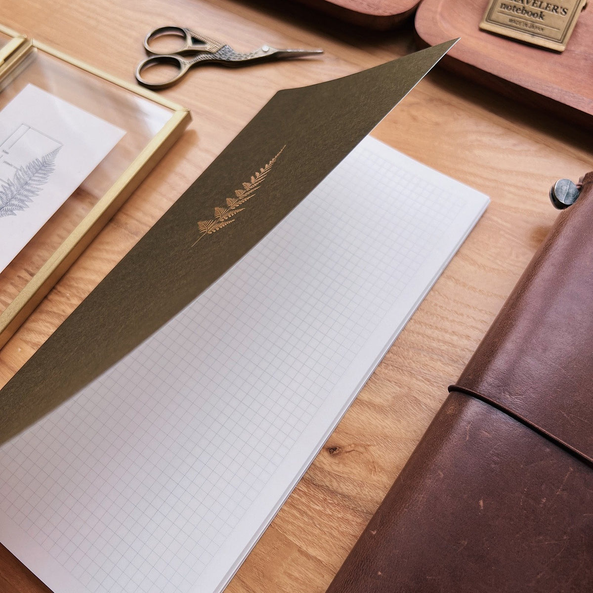 Sarica Studio Fern Notebook, standard TN size, cover lifted to show the gridded Tomoe River paper