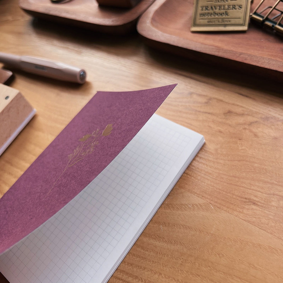 Sarica Studio Floral Notebook, passport TN size, cover lifted to show the gridded Tomoe River paper