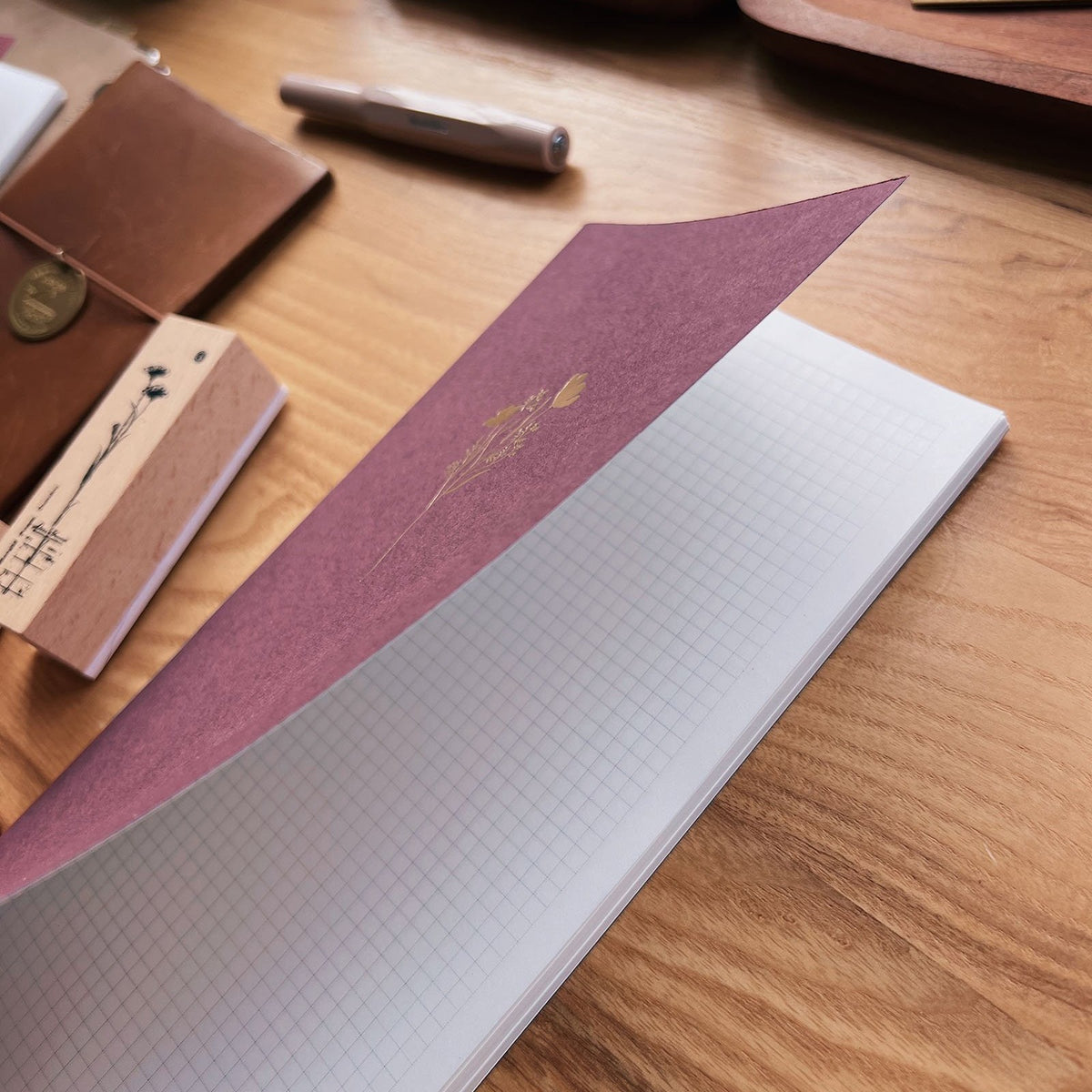 Sarica Studio Floral Notebook, standard TN size, cover lifted to show the gridded Tomoe River paper