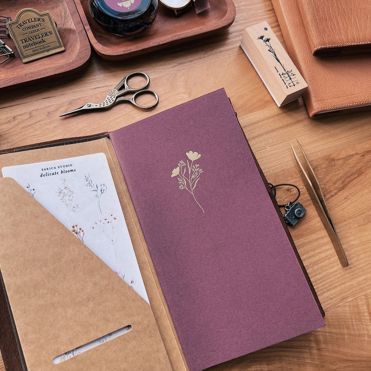 Sarica Studio Floral Notebook, standard TN size, in a traveler's notebook cover with a kraft pocket folder