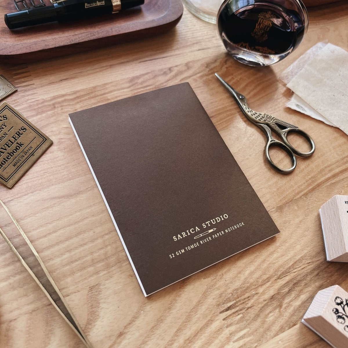Sarica Studio Ginkgo Notebook, passport TN size, back cover shown at an angle on a wooden desk
