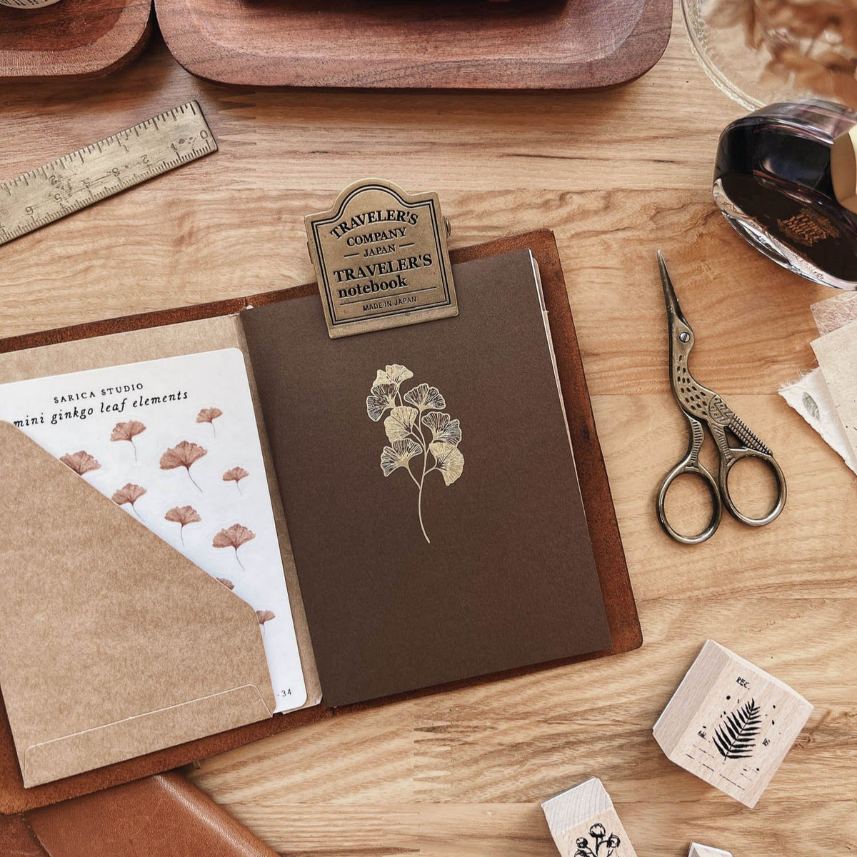Sarica Studio Ginkgo Notebook, passport TN size, in a leather passport cover with a kraft pocket and a ginkgo sticker sheet