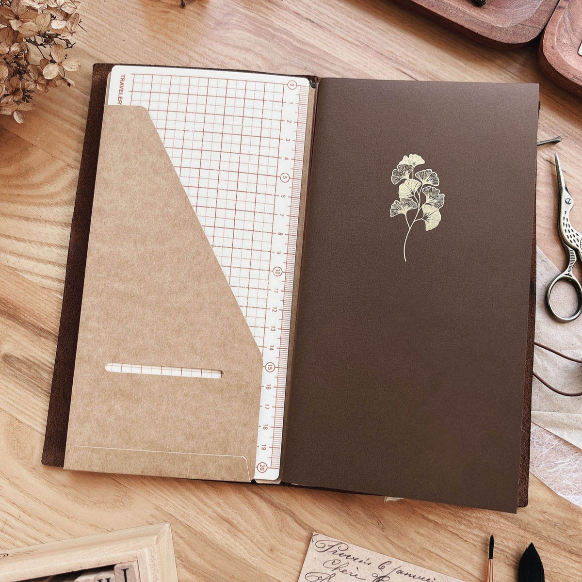 Sarica Studio Ginkgo Notebook, standard TN size, in a traveler's notebook cover with a kraft pocket folder and grid insert
