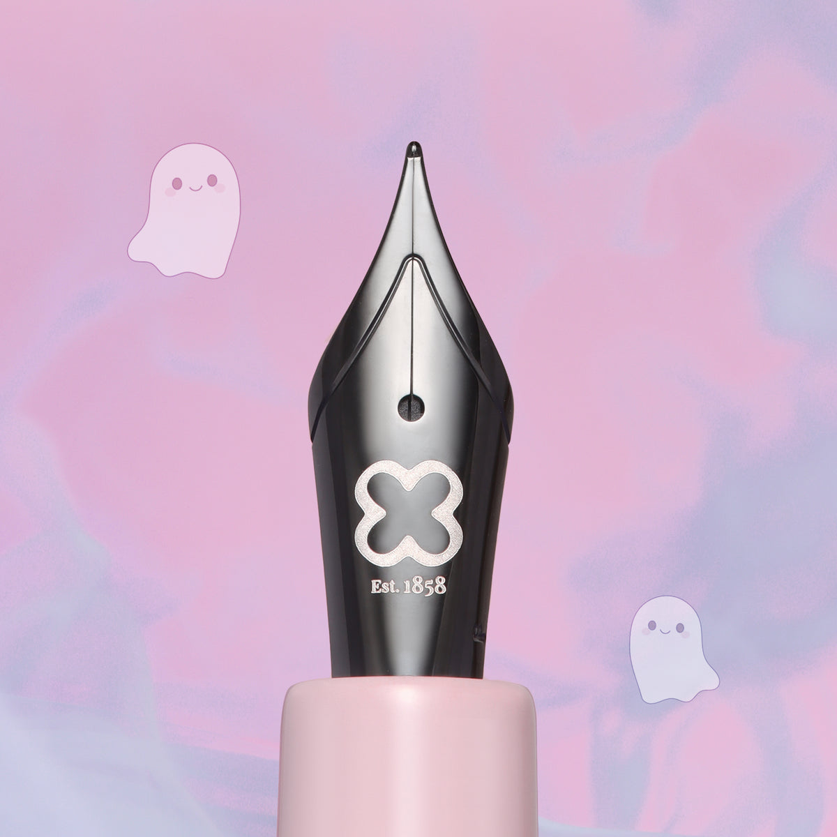 Close-up of the black Esterbrook steel nib with the silver Esterbrook logo and Est. 1858, on the pink grip of the Pastel Halloween Estie