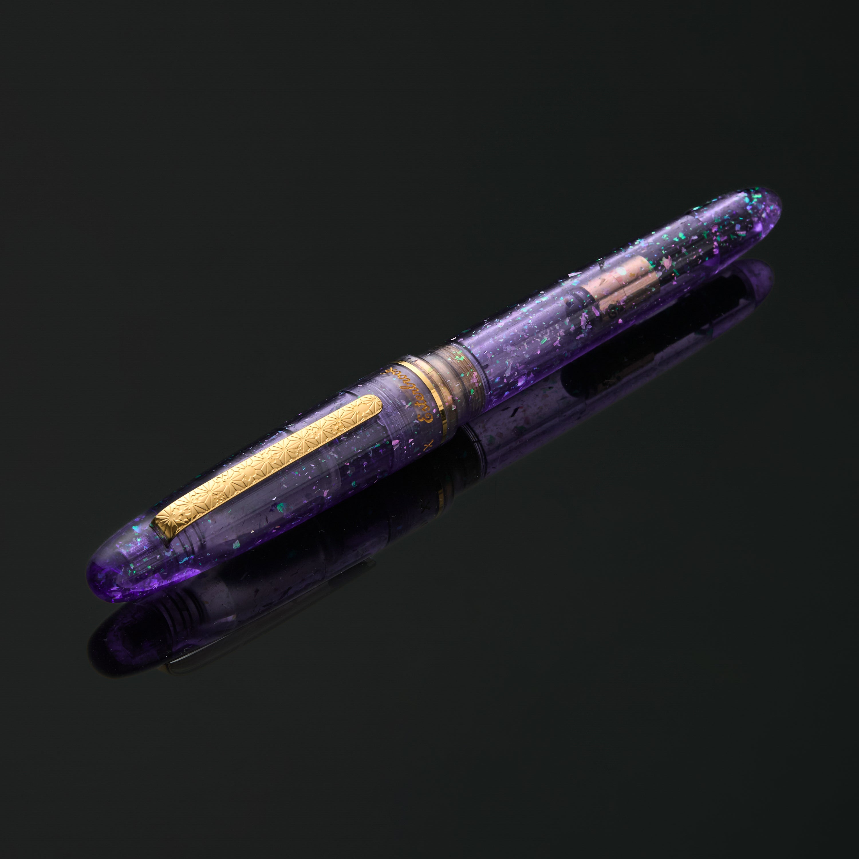 Esterbrook x Sakuradragon Sakura Street Estie fountain pen, capped, resting horizontally on dark background