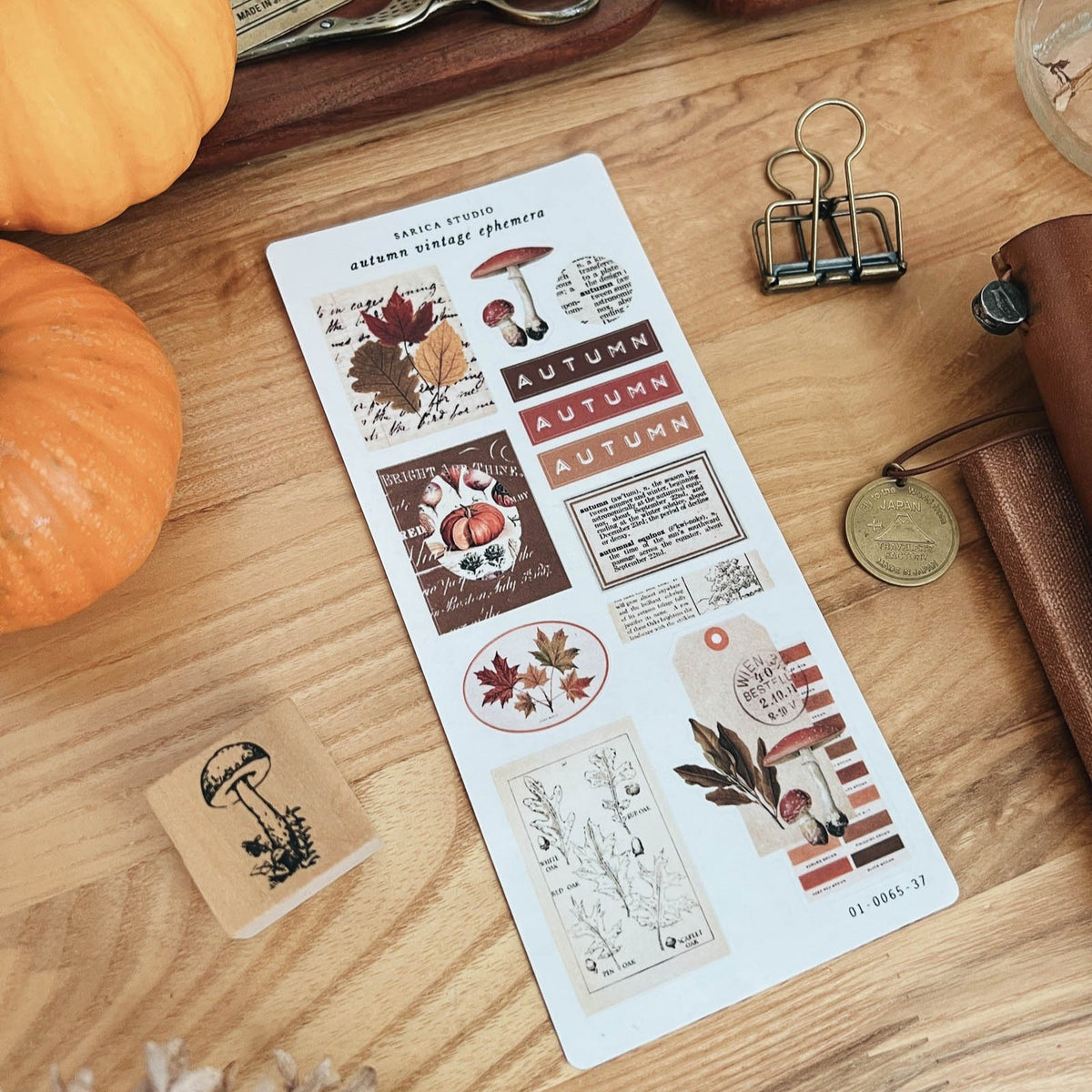 Sarica Studio Autumn Vintage Ephemera stickers with pumpkins on a desk