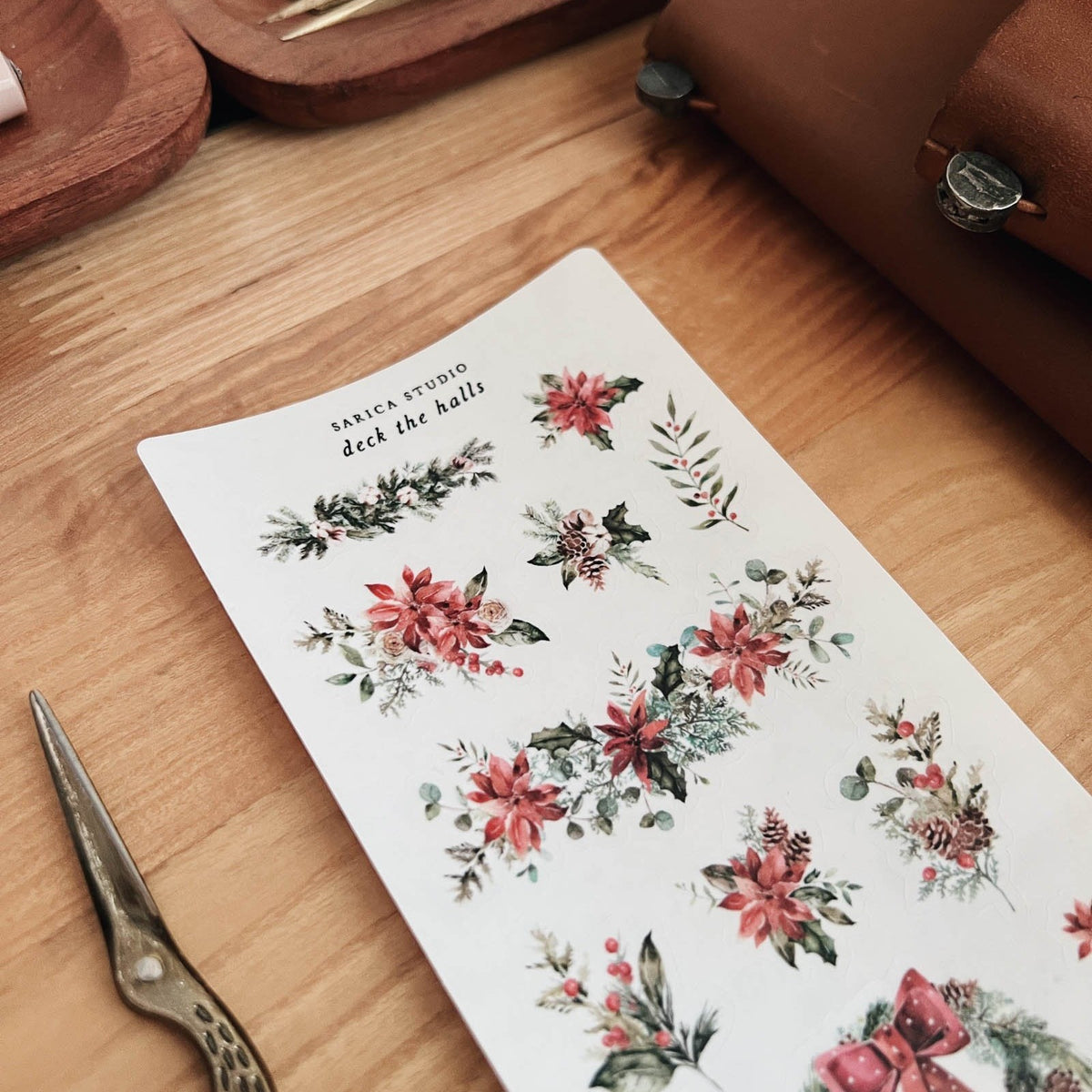 Close-up of Sarica Studio Deck the Halls stickers of red poinsettias and holly