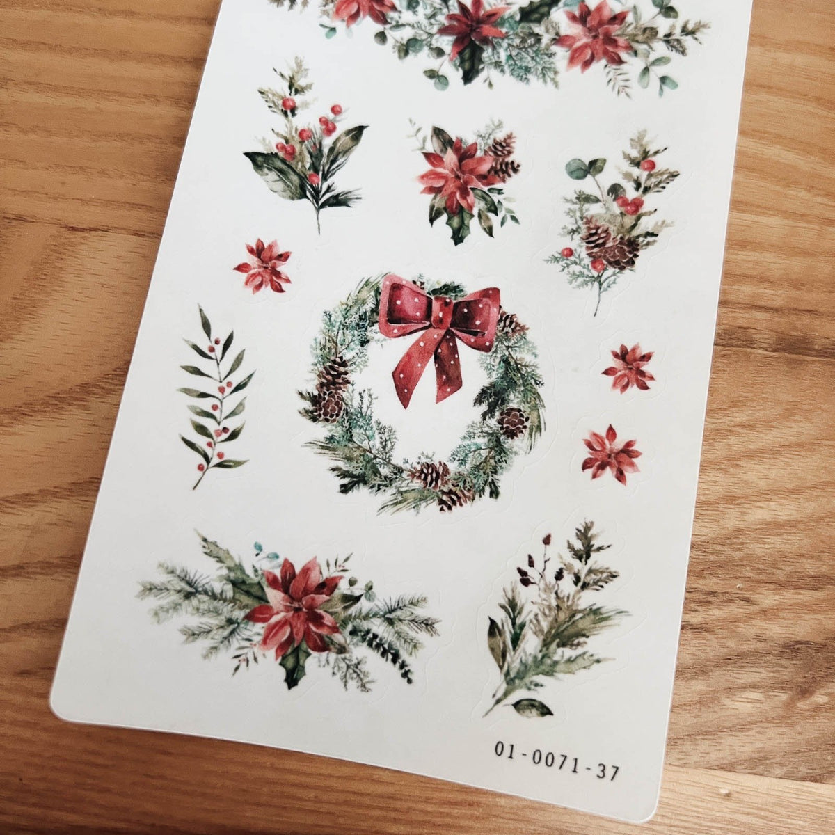 Close-up of Sarica Studio Deck the Halls stickers with a wreath tied with a red bow