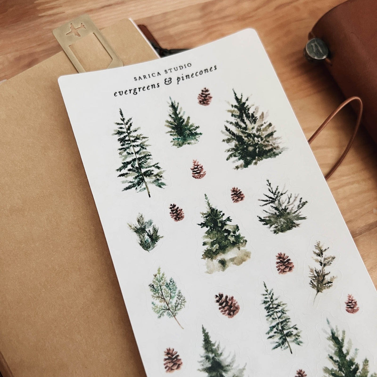 Sarica Studio Evergreens & Pinecones sticker sheet shown at an angle