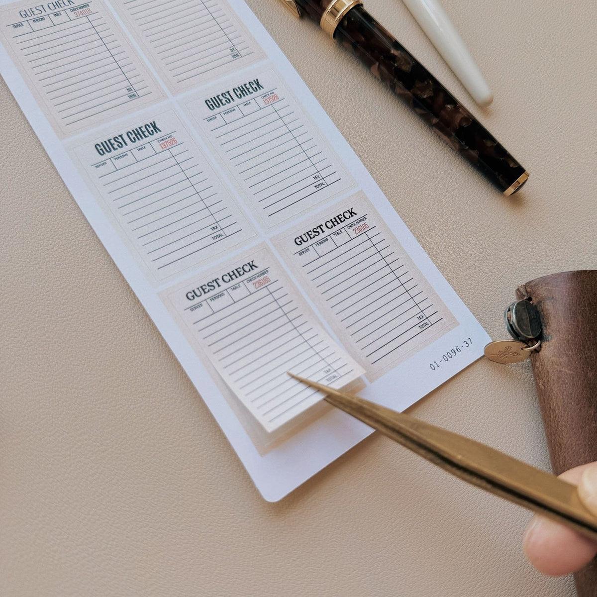 Sarica Studio Vintage Guest Checks stickers, being written on with a pen