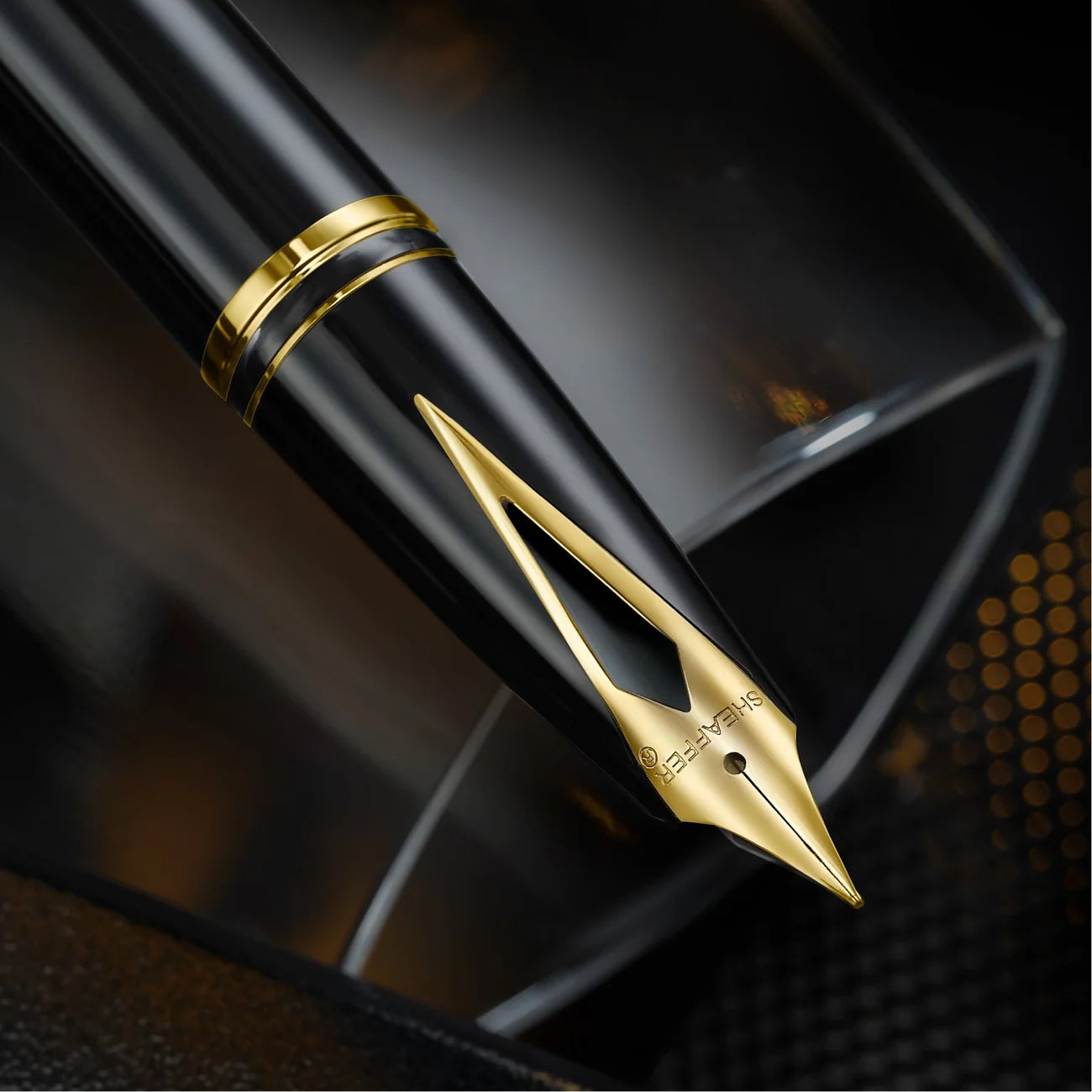 Close view of the Sheaffer Legacy inlaid nib, a flat gold-plated triangle set flush into the black section