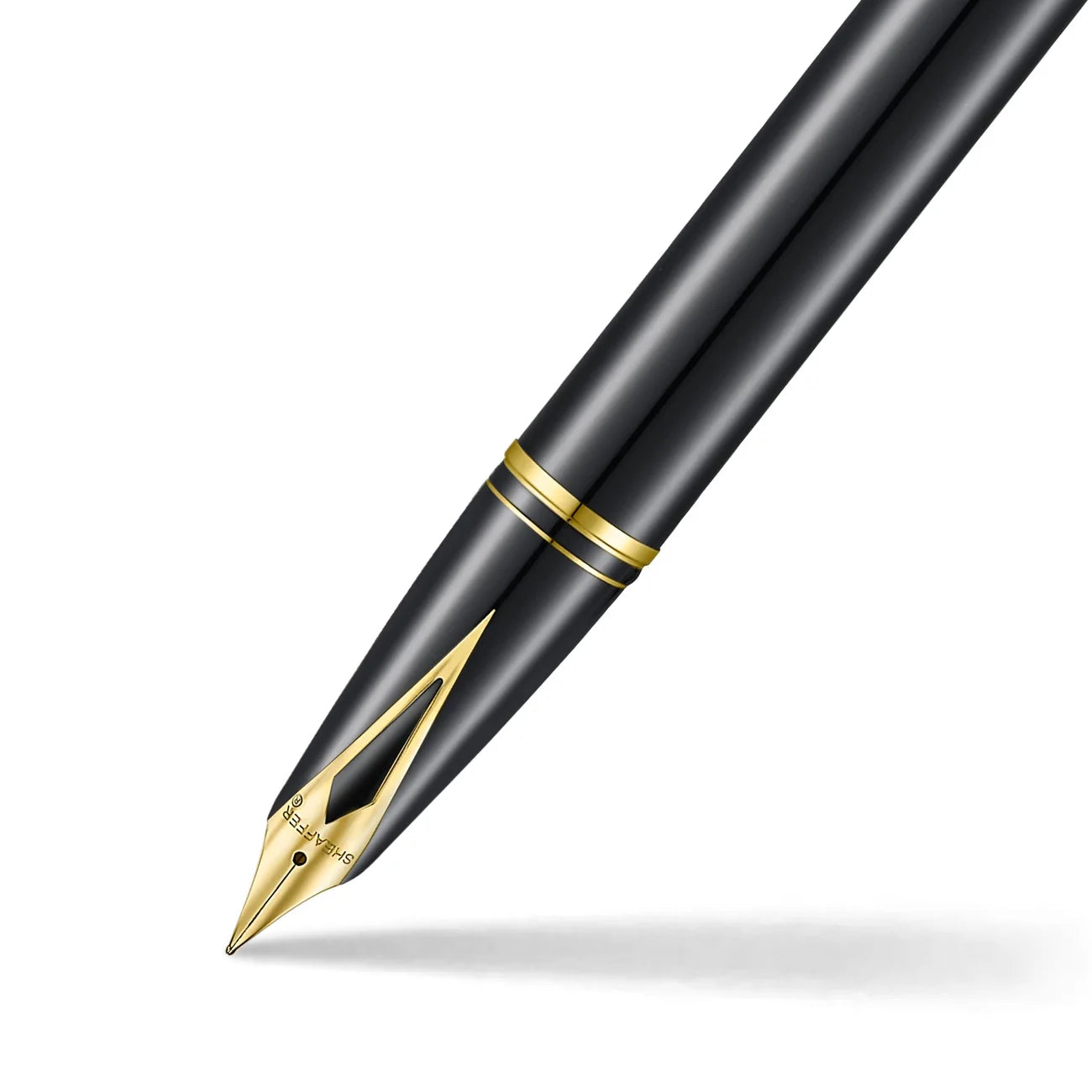 Sheaffer Legacy fountain pen in glossy black with gold trim, shown at an angle with its inlaid gold-plated nib in the foreground