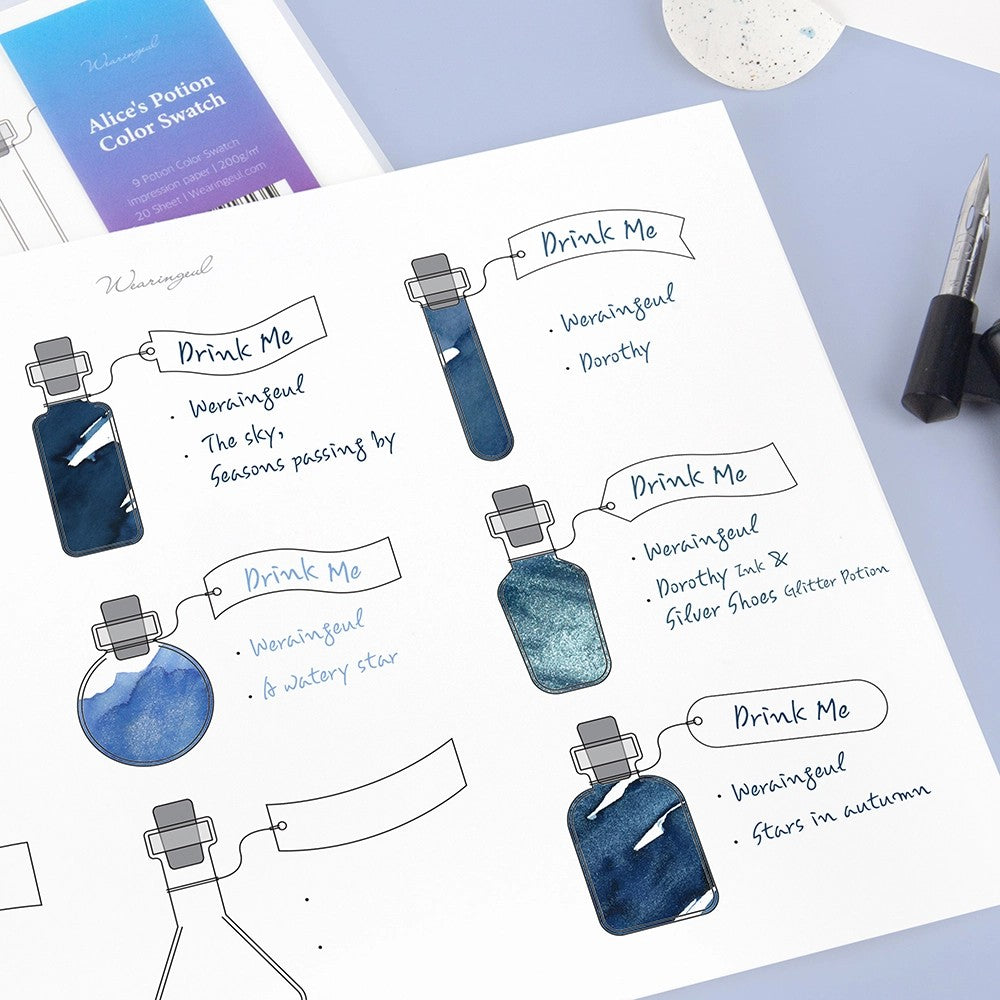 Alice's Potion swatch sheet with blue ink swatches in potion bottles and Drink Me tags written by hand