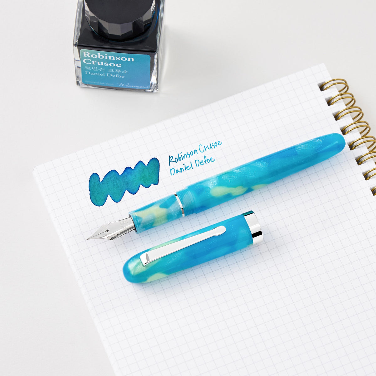 Wearingeul Robinson Crusoe fountain pen on grid paper with a writing sample in Robinson Crusoe ink