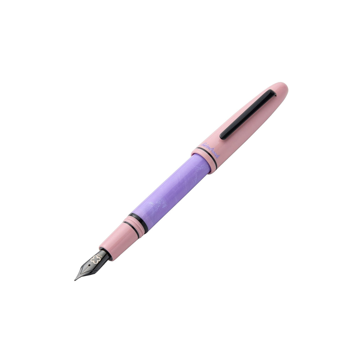 Pastel Halloween Estie fountain pen with the pink cap posted on the purple barrel, showing the black nib