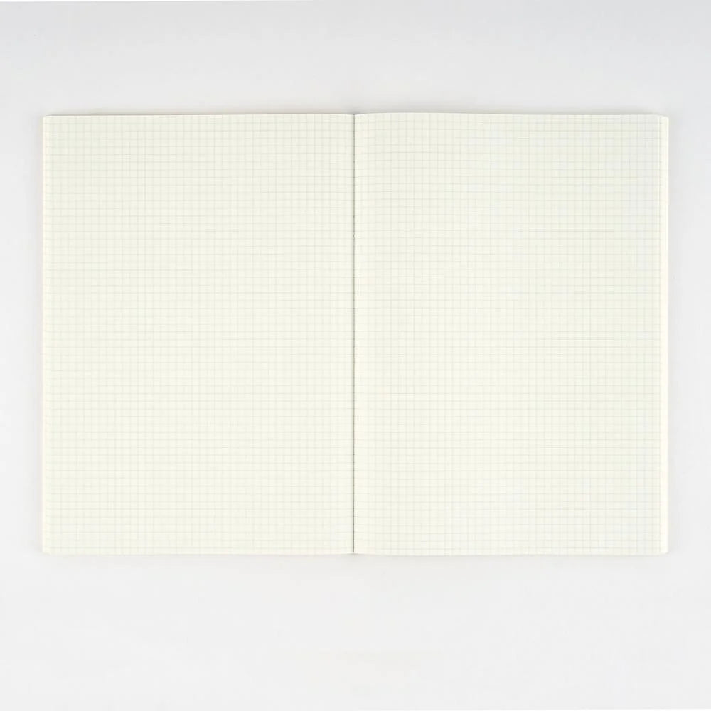 Hobonichi Graph Notebook A5 open flat, showing two cream Tomoe River pages ruled in a fine 3.7 mm grid