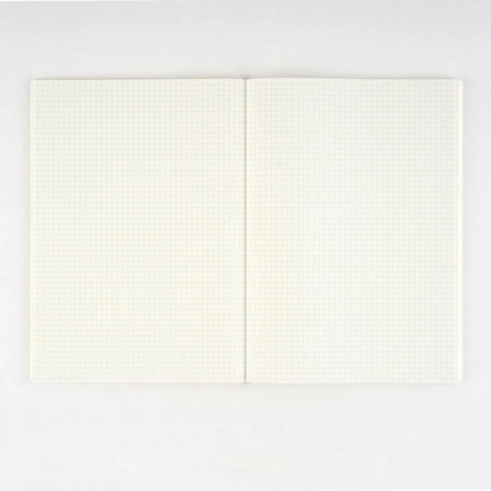 Hobonichi Graph Notebook A6 open flat, showing two cream Tomoe River pages ruled in a fine 3.7 mm grid