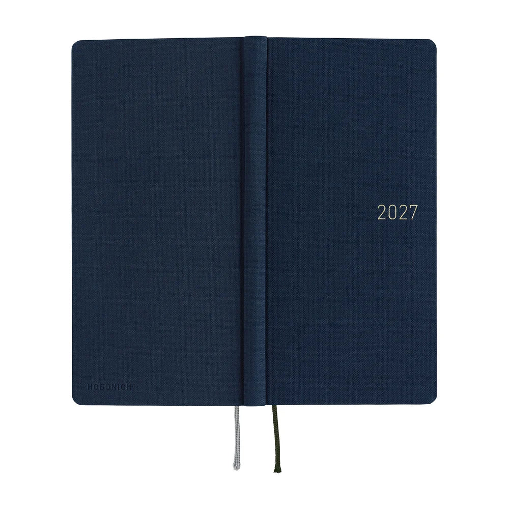 Hobonichi Techo 2027 Weeks planner, Colors Midnight Blue — laid flat showing the slim spine and the navy cloth across front and back