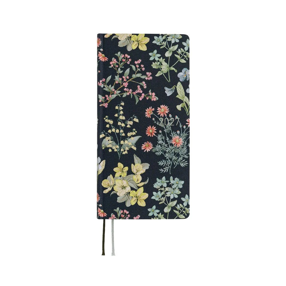 Hobonichi Techo 2027 Weeks planner, Liberty Fabrics Floral Remedy — navy blue front cover printed with a pale watercolor herb garden and the year in matte silver foil