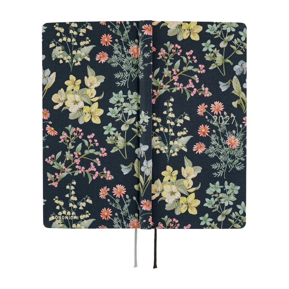 Hobonichi Techo 2027 Weeks planner, Liberty Fabrics Floral Remedy — laid flat showing the navy floral cover wrapping front, spine and back