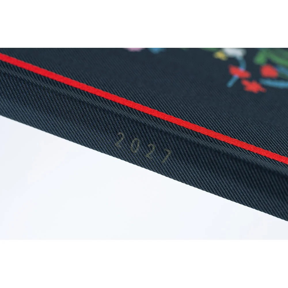 Hobonichi Techo 2027 Weeks planner, Yoshie Watanabe Petit Bloom — spine showing the year and the artist's signature in black foil