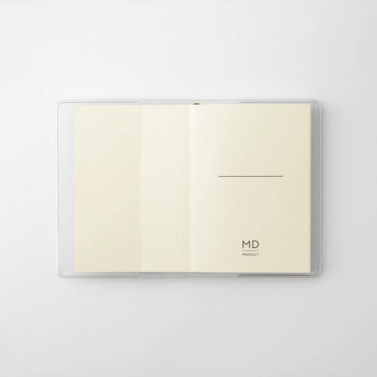 MD Notebook A7 opened inside its clear PVC cover, showing cream MD Paper and the MD Product logo