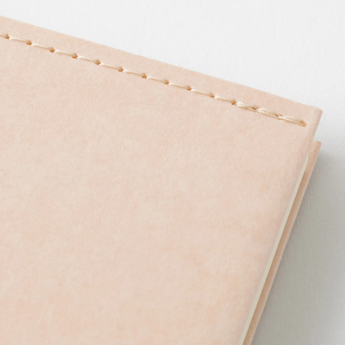 Close-up of the stitched corner and edge of the MD Notebook A5 paper cover in light pink Cordoba paper